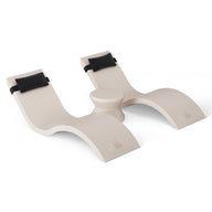 The Outdoor Paradise In-Pool Furniture Bundle by Ledge Lounger features a modern white wooden rocking toy with a sleek, wavy design, padded black straps, an artistic abstract shape, and rests on a plain white background.