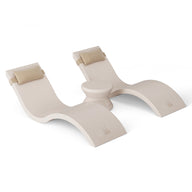 The Outdoor Paradise In-Pool Furniture Bundle by Ledge Lounger features a sleek white, wave-shaped yoga prop with curved sections and padded supports, reminiscent of stylish in-pool chaise loungers, complete with a central cylindrical piece for enhanced functionality.
