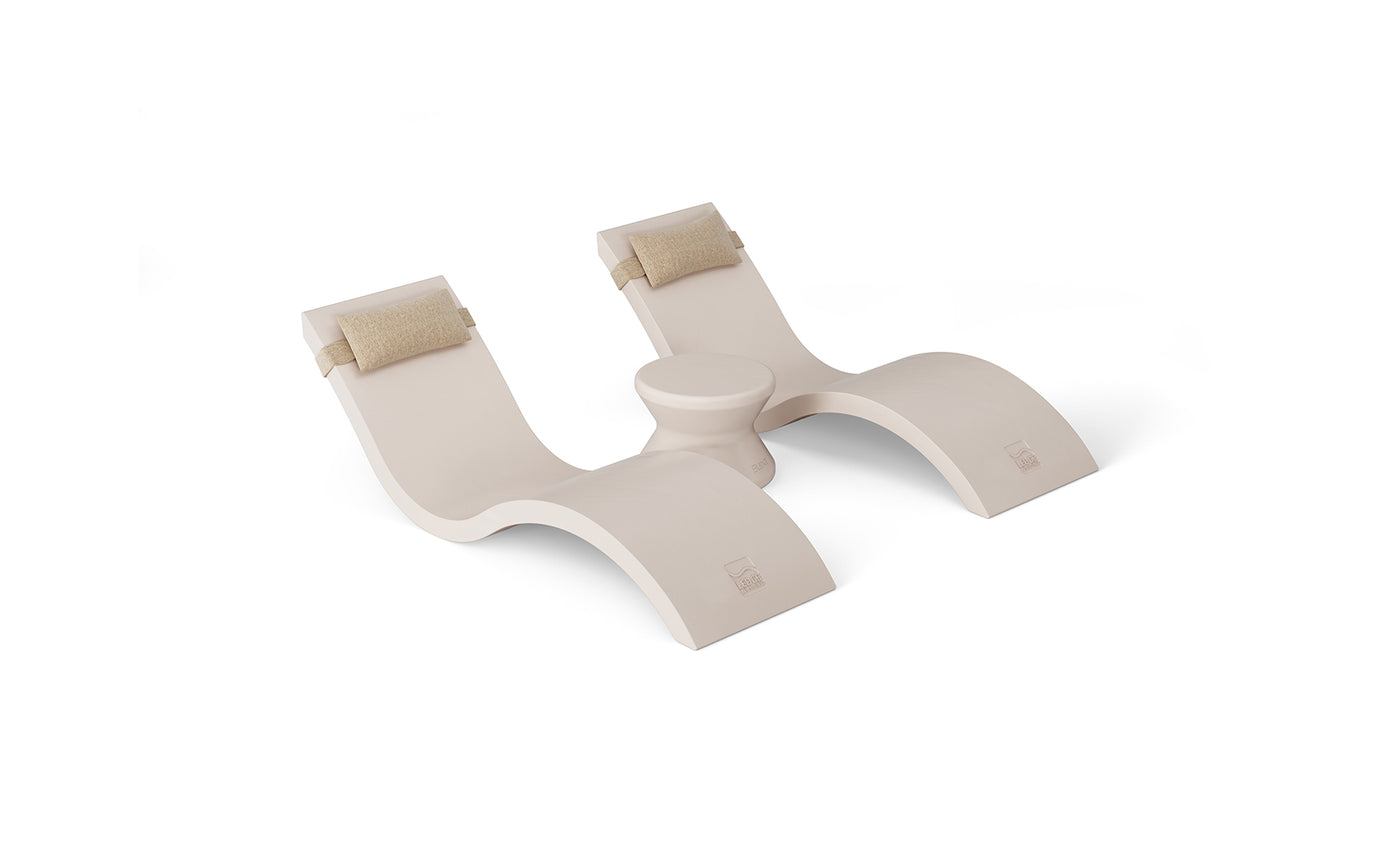 The Outdoor Paradise In-Pool Furniture Bundle by Ledge Lounger features a sleek white, wave-shaped yoga prop with curved sections and padded supports, reminiscent of stylish in-pool chaise loungers, complete with a central cylindrical piece for enhanced functionality.