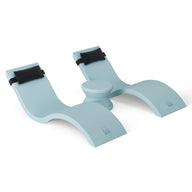 The Ledge Lounger Outdoor Paradise In-Pool Furniture Bundle includes a light blue ergonomic footrest with two curved supports and black straps, designed to enhance comfort and improve posture by the pool, all set against a pristine white background.