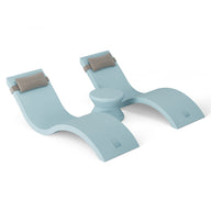 The Outdoor Paradise In-Pool Furniture Bundle by Ledge Lounger is a light blue, wavy-shaped yoga prop with cushioned supports and a central knob, reminiscent of chaise loungers. Its minimalist design stands out against a white background, inviting dreams of an outdoor paradise.