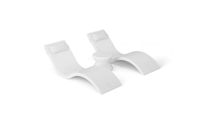 The Outdoor Paradise In-Pool Furniture Bundle by Ledge Lounger features two modern white chaise loungers with headrests side by side, separated by a small table. With smooth, curved lines on a solid white background, its the perfect pool ledge furniture setup.