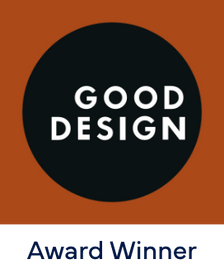 A black circle with the words “GOOD DESIGN” in white, centered on a brown-orange background. Below the circle, the text “Award Winner” appears in dark blue.