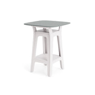 The Ledge Lounger Haven Hightop Table features a modern, square top in light gray with white open-frame legs and a lower storage shelf—ideal for stylish, contemporary outdoor spaces.